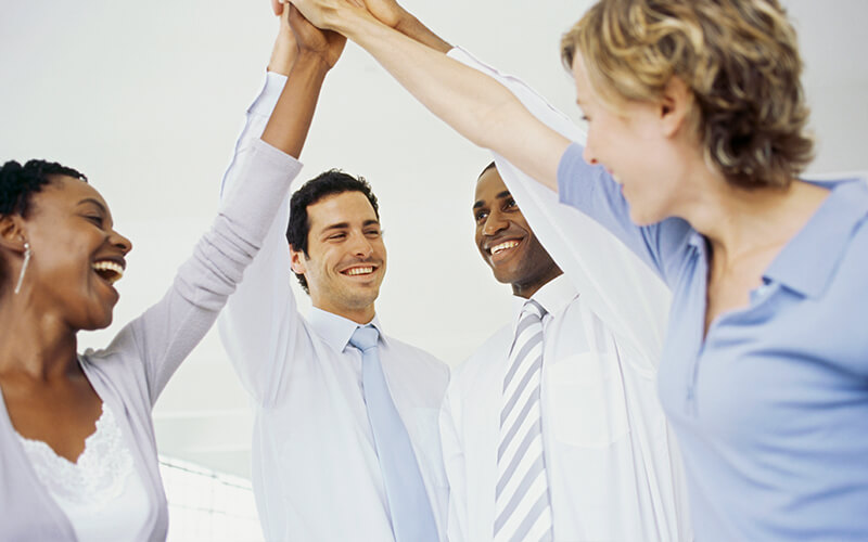 Image of a diverse business people, holding there hands up in the air.